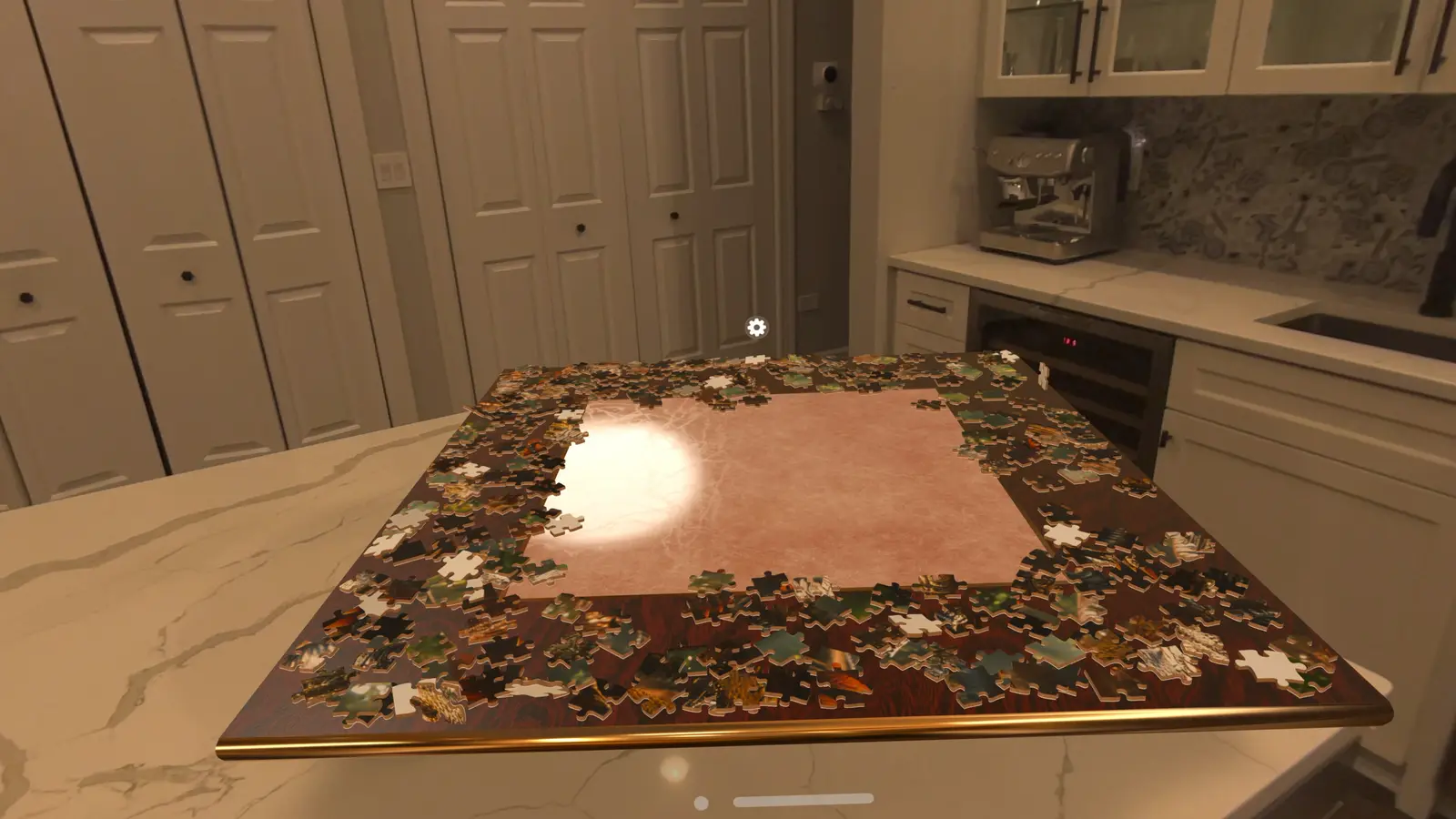 A large puzzle board on a kitchen counter in Apple Vision Pro, with loose pieces dropped around its frame