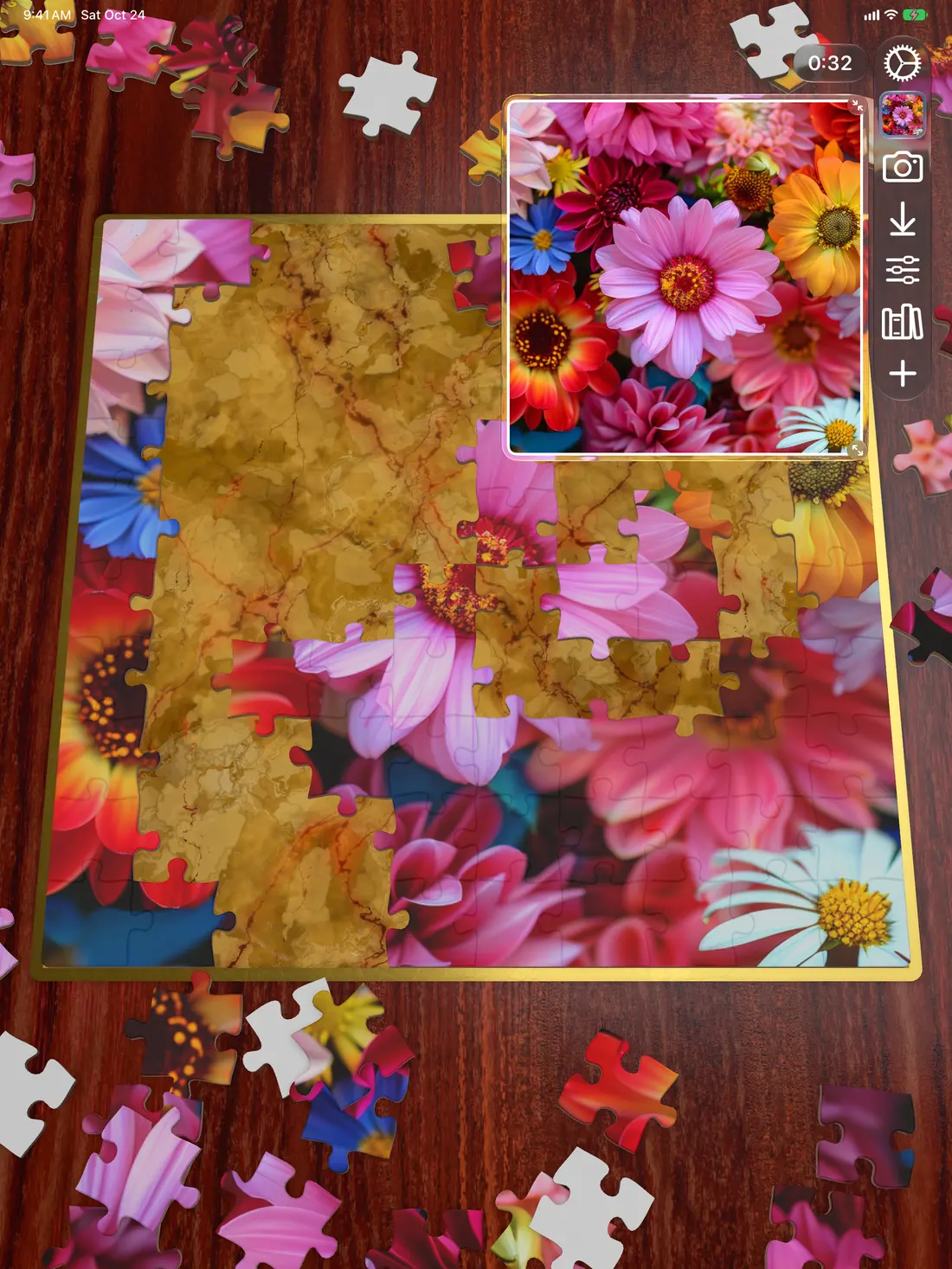 A flower puzzle partly assembled on iPad, on a dark red wood board