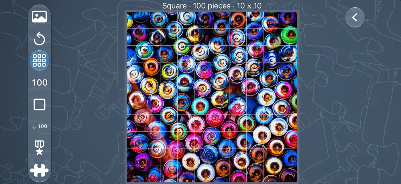 The Create screen on iPhone in landscape, showing a spray-can picture on a 10 by 10 grid with the layout and piece-count controls